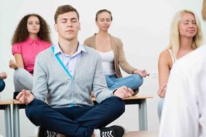 employees meditating in corporate wellness program