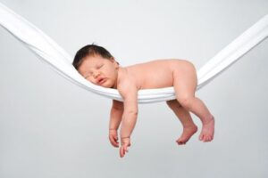 infant sleeping on tummy on a hammock